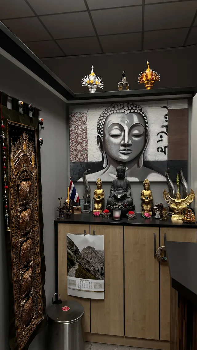 Corner with a large Buddha portrait and Thai ornaments